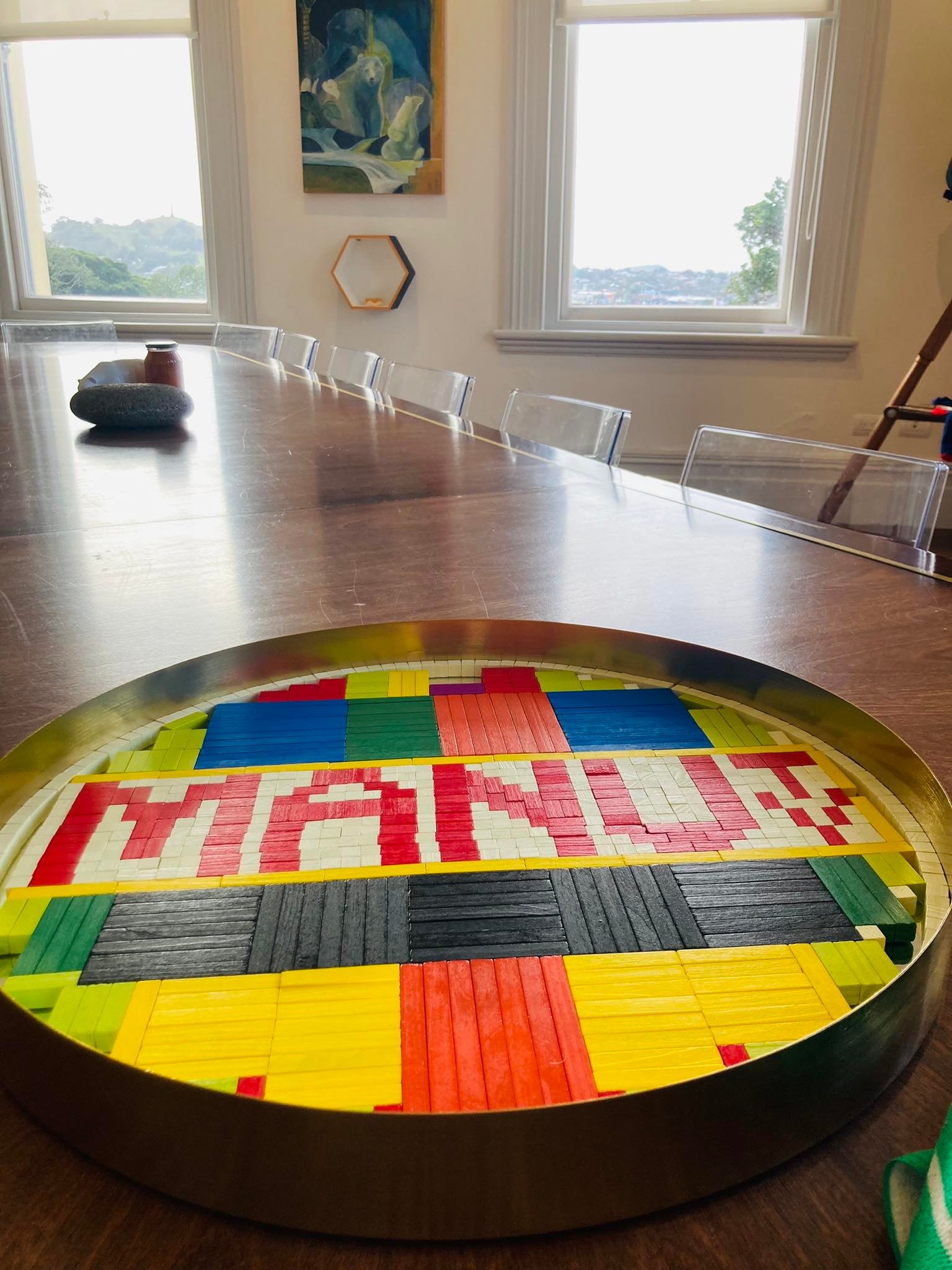 A tray of cuisenaire rods spell out a TV test pattern and the words MANU TV